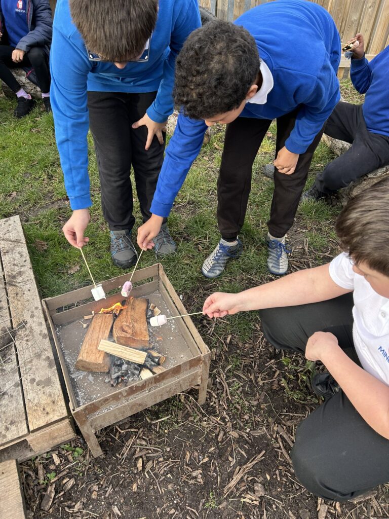 Pupils at Minerva Academy enjoy campfire treats